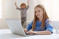 Enthusiastic pretty girl preparing essay for tomorrow