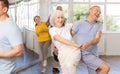 Enthusiastic senior couple practicing jive in group dance class Royalty Free Stock Photo