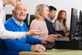 Enthusiastic senior man taking computer lessons