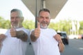 Enthusiastic smiling senior man giving a thumbs up of success Royalty Free Stock Photo