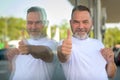 Enthusiastic smiling senior man giving a thumbs up of success Royalty Free Stock Photo