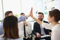 Enthusiastic teammates high-fives celebrate shared accomplishments and corporate success Royalty Free Stock Photo