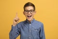 Enthusiastic teen boy wearing glasses pointing upwards with finger Royalty Free Stock Photo