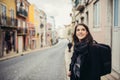 Enthusiastic traveler woman walking streets of european capital.Tourist in Lisbon,Portugal