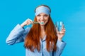 Enthusiastic upbeat, lively redhead woman, foxy girl with pretty smile, brushing teeth holding toothbrush and glass