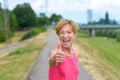 Enthusiastic woman giving a thumbs up gesture