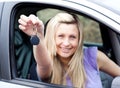 Enthusiastic young driver holding a key