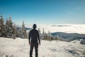 Enthusiastic young traveller enjoys the view from the highest mountain of the Beskydy Mountains in Central Europe of the snowy