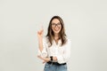 Enthusiastic young woman with glasses cheerfully pointing upwards Royalty Free Stock Photo