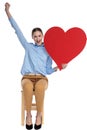 Enthusiastic young woman holding big red heart Royalty Free Stock Photo