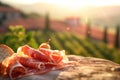 Elegant prosciutto display, with a Tuscan vineyard softly blurred in the background.