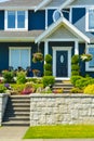 Entrance of luxury family house with landscaped front yard on land terrace