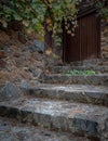 Entrance of an abandoned house with closed wooden doors and stoned stairs Royalty Free Stock Photo