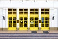 Entrance into an administrative building with yellow doors and Royalty Free Stock Photo