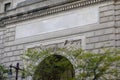 Entrance arch of a fancy stone building with a blank name stone