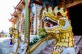 Entrance of an Asian colorful temple with the statues of dragons in Thailand