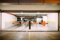 Entrance with a barrier to a large underground parking lot with parked cars Royalty Free Stock Photo