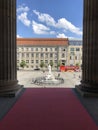 Entrance of the Berliner Schauspielhaus with red carpet, overlooking the Schillerbrunnen at Gendarmenmarkt.