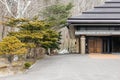 Entrance with big Bonsai trees near Shiraoi Ainu Village Museum in Hokkaido, Japan