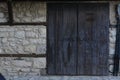 Entrance of building with old wooden doors in stone wall outdoors Royalty Free Stock Photo