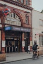 Entrance of Camden Town Underground station, London, UK, cyclist riding past