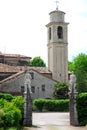 Entrance with church and bell tower in PortobuffolÃÂ¨ in the province of Treviso in the Veneto (Italy) Royalty Free Stock Photo