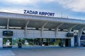 Entrance for departures in airport building with sign Zadar Airport