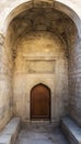 The entrance door in the old stone wall leads to the interior of the Muslim mosque.