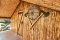 Entrance door to the hut where the tavern or pub is located with an epic shield and crossed axes as a greeting