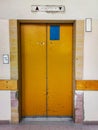 Entrance doors to old metal elevator in old hospital