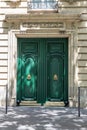 Entrance with double door painted in bright green color. Elegant doorway of white stone building in Paris France. Green door. Royalty Free Stock Photo