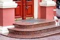 Entrance double door with threshold with marble steps.