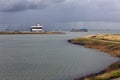 Entrance Dutch canal Terneuzen and cargo ship sailing river Schelde