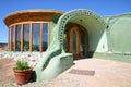 Entrance of an Earthship sustainable house made out of adobe and upcycled glass bottles near Taos in New Mexico, USA Royalty Free Stock Photo