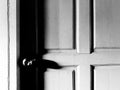 Entrance, Exit or door closed with knob, sunlight and shadow in black and white style for background with copy space Royalty Free Stock Photo