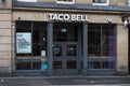 Entrance facade to Taco Bell cafe restaurant in high street location with sign branding and logo Royalty Free Stock Photo