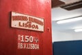 Entrance of fire station Bombeiros VoluntÃÂ¡rios de Lisboa. Detail of red sign of