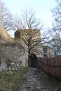 Entrance gate of castle Girls Stone behind tree