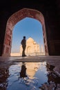 tourist standing in front entrance gate of Taj Mahal indian palace. Islam architecture. Door to the mosque