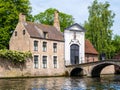 Entrance gate to Begijnhof, Beguinage, and bridge over canal in Bruges, Belgium Royalty Free Stock Photo