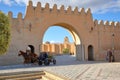 Entrance gate to Kairouan eastern side of the city, with the dome and the minaret of the Great Mosque in the background