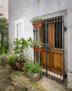 Entrance with grille and flowers, brown wood in Cres