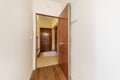 Entrance hall of a detached house with armored doors with sapele paneling and wooden tiled floor Royalty Free Stock Photo