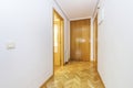 Entrance hall of a house with French oak parquet floors placed in a herringbone pattern with armored access doors, built-in