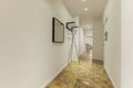 Entrance hall of a house with a long corridor with a light varnished oak floor Royalty Free Stock Photo