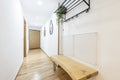 Entrance hall of a residential house with a wooden bench made of a plan