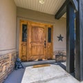 Entrance of home with brown door and sunny porch Royalty Free Stock Photo
