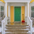 Entrance of home with stairs and green front door Royalty Free Stock Photo