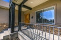 Entrance of a home with sunlit stairs and porch Royalty Free Stock Photo