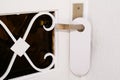 Entrance home with white door hanger of hotel room with empty sign please do not disturb Royalty Free Stock Photo